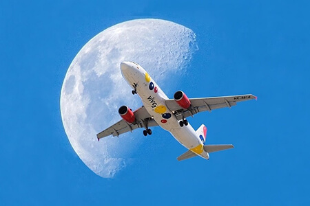 plane flying past moon